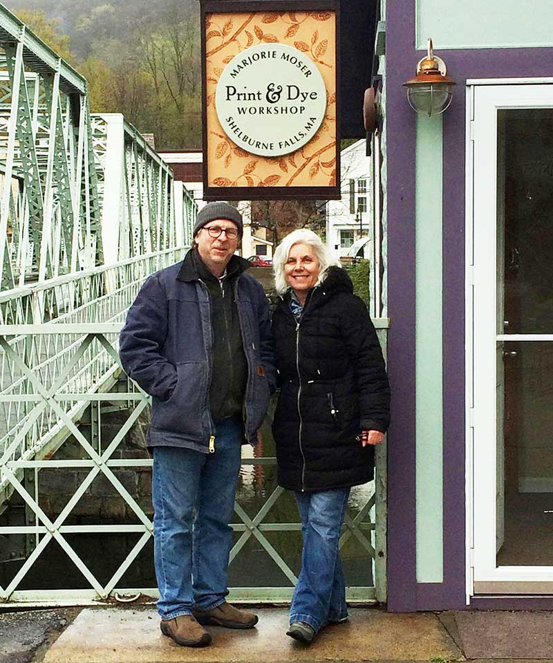 Marjorie and Peter Moser in front of shop